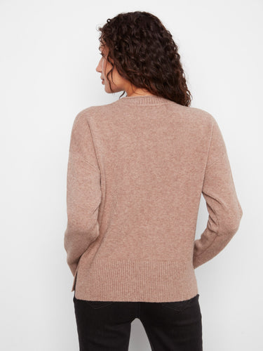 The soft texture and ribbed hem of this sweater add an extra touch of elegance to its overall design. A must-have piece by Charlie B.
