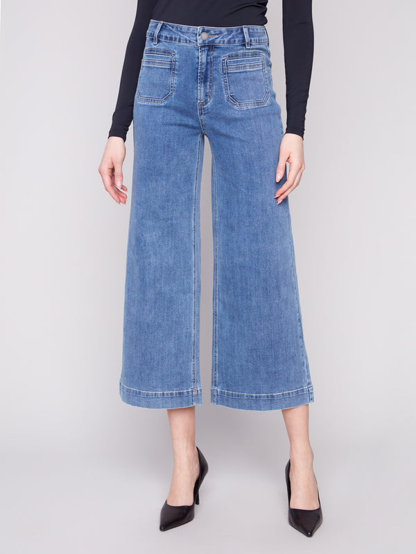 Cropped length medium blue jeans featuring both front patch and back pockets for added style by Charlie B.