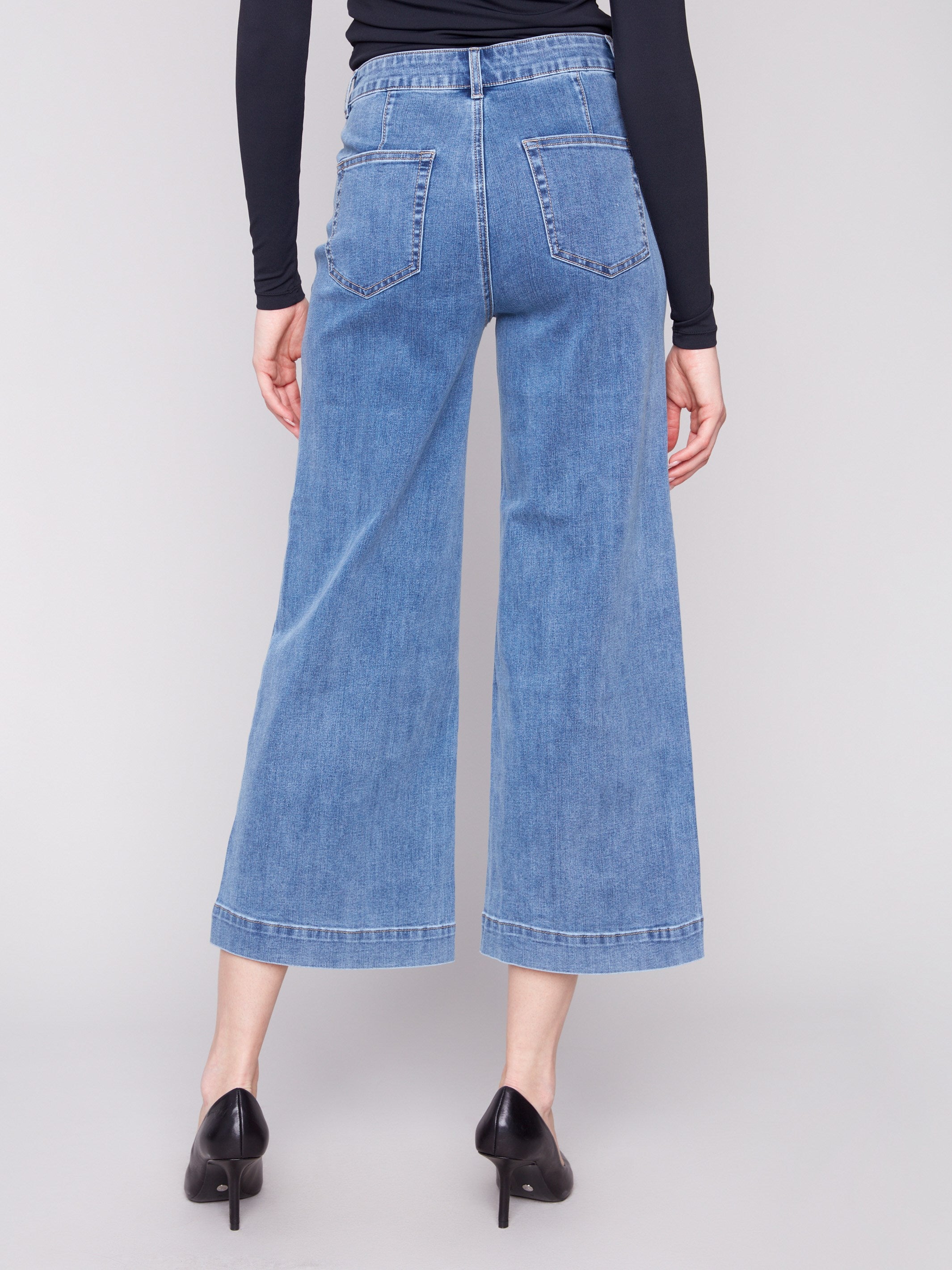 Designed with stretch denim fabric, these medium blue jeans provide flexibility and ease of movement by Charlie B.