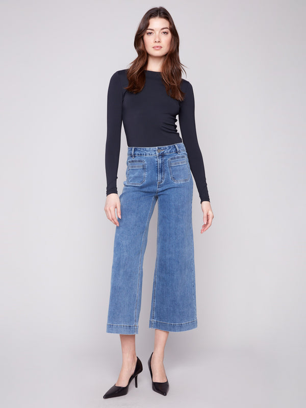 Featuring functional front patch pockets, these cropped flare jeans blend practicality with fashion effortlessly by Charlie B.