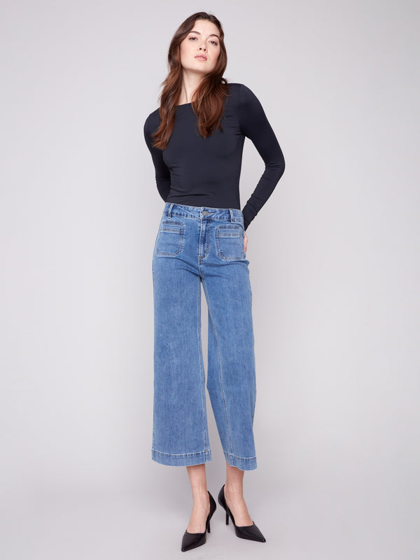 Medium blue cropped flare jeans with patch pockets, featuring a regular rise and modern fit by Charlie B.