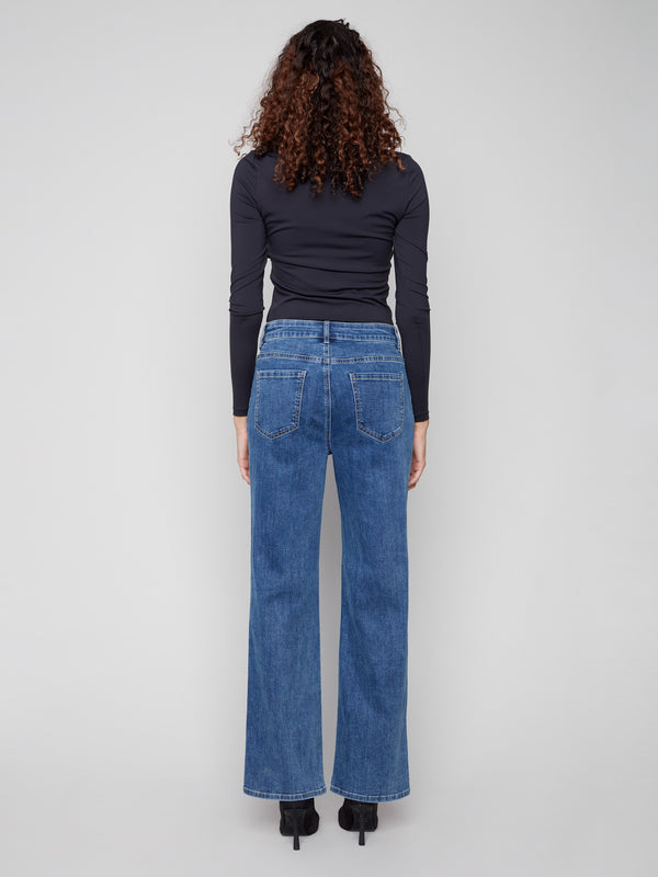 The back view showcases the long length of these flare jeans, complete with functional back pockets by Charlie B.