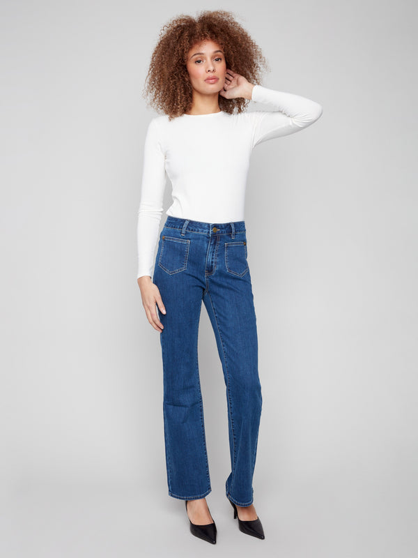 Indigo jeans with a flare leg design, featuring front patch pockets and back pockets for added style by Charlie B.