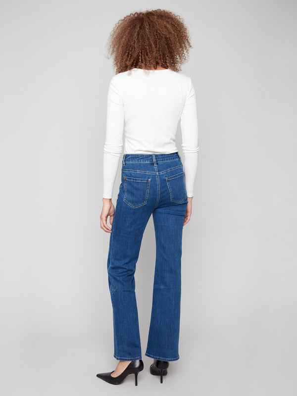 Designed with back pockets, these indigo flare jeans combine functionality with fashion-forward elements by Charlie B.