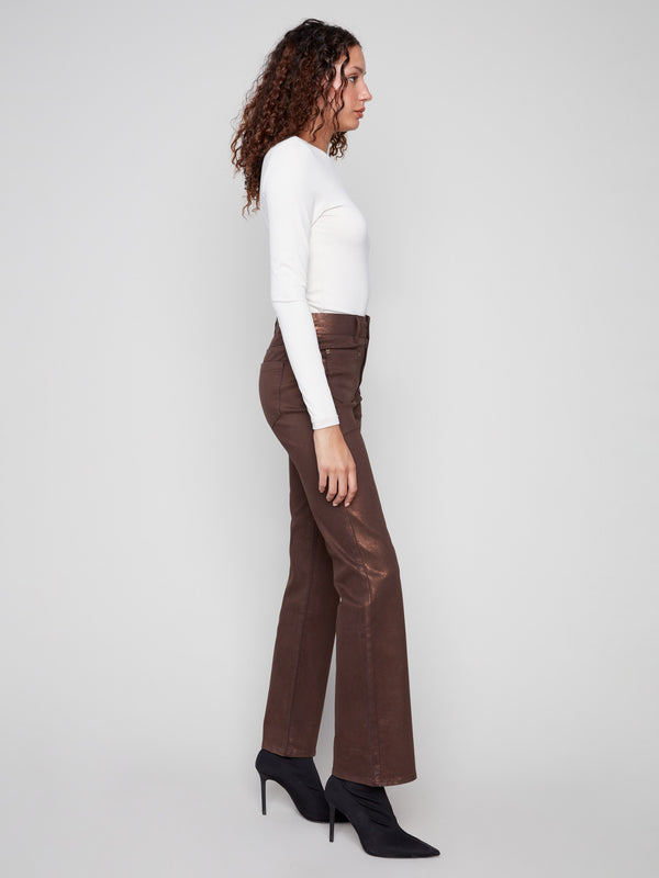 Bronze metallic finish pants designed with a flattering flare leg and unique rivet accents by Charlie B.