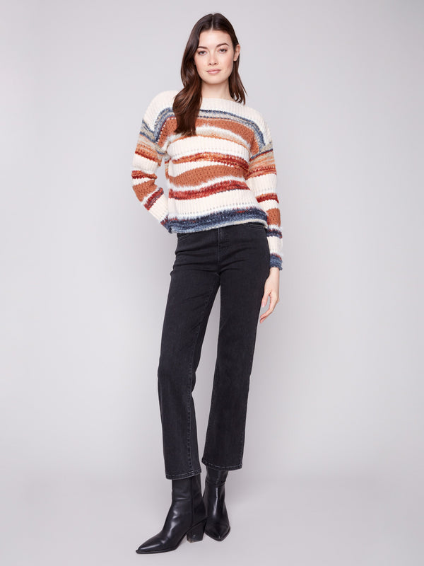 Cozy knit sweater in sepia tones with intricate patchwork details, ideal for layering in cooler weather by Charlie B.