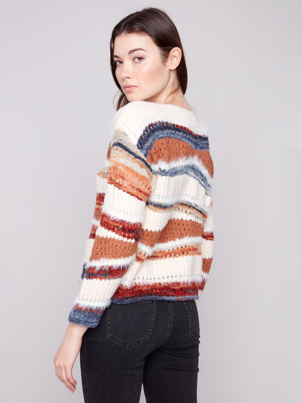 Ribbed cuffs and vibrant stripes enhance the classic crew neckline of this stylish knit sweater by Charlie B.