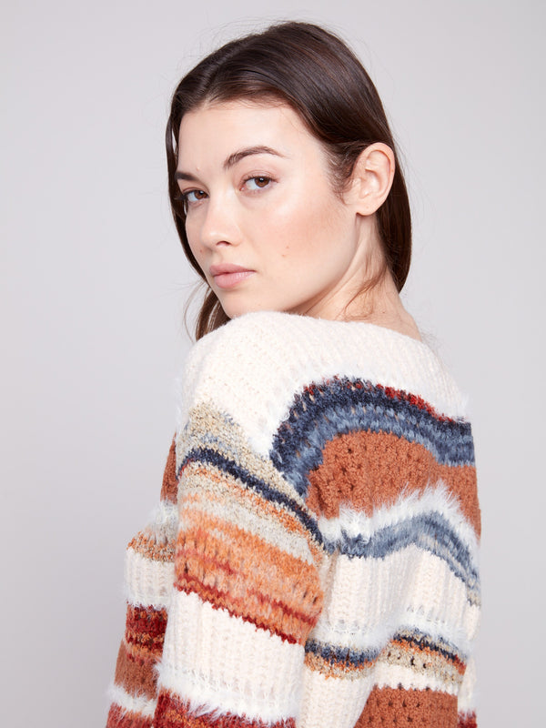This sepia-toned knit features a drop shoulder design and colorful stripes, adding flair to any casual outfit by Charlie B.