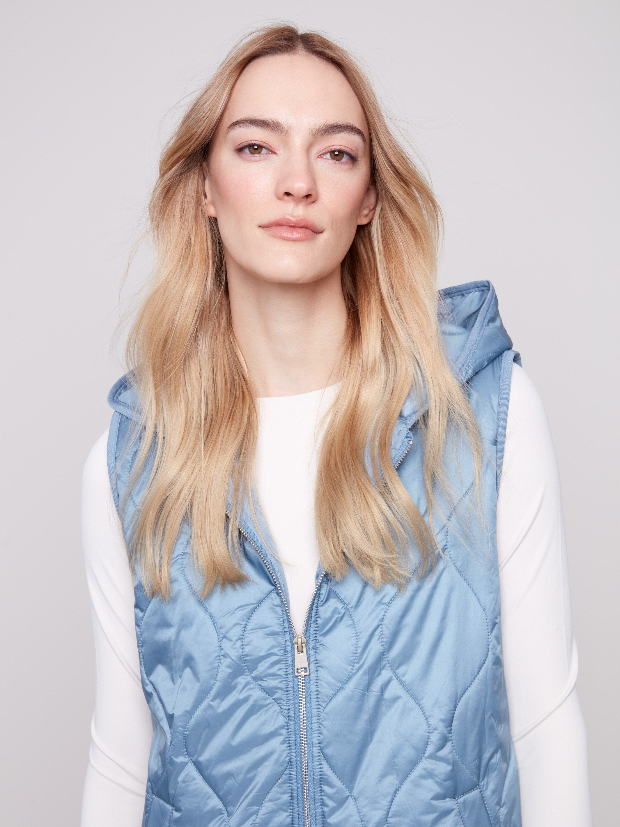 Elegant Oxford vest showcasing side snap buttons and a chic hooded design by Charlie B.