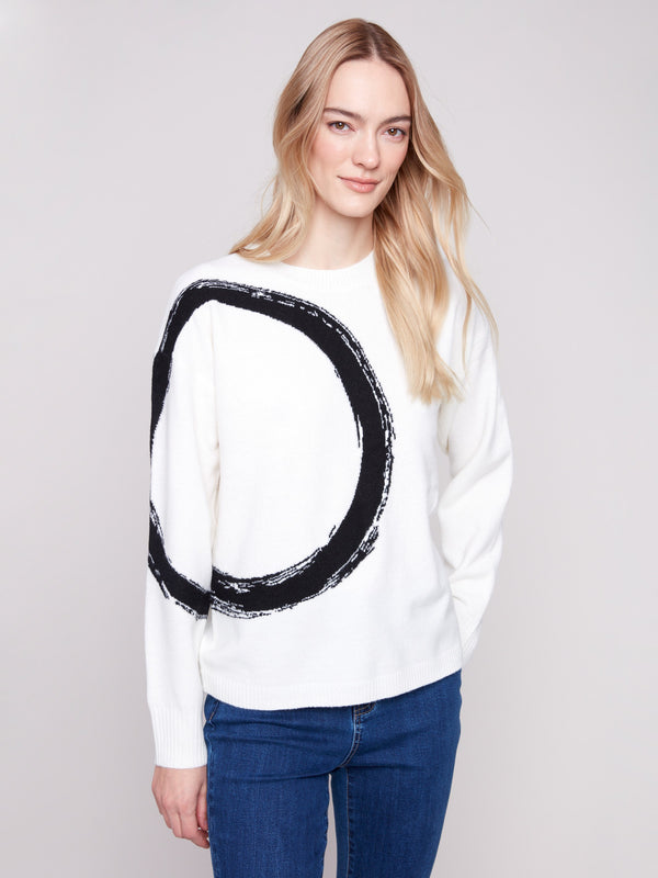Ecru sweater featuring a crew neck and bold black abstract circle pattern, perfect for a cozy look by Charlie B.