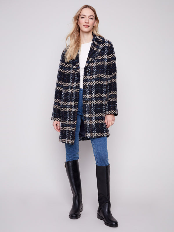 Stay warm and stylish in this navy plaid boucle coat that combines modern design with classic elements. By Charlie B.