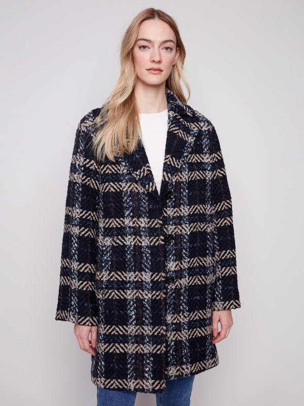 Versatile and fashionable, this navy plaid boucle coat is perfect for layering over any ensemble effortlessly. By Charlie B.