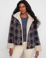 Navy plaid boucle jacket featuring a stand collar and sherpa trim, perfect for cozy style by Charlie B.