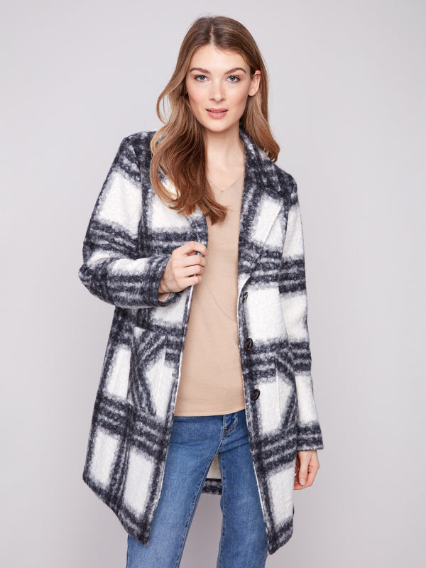 This boucle knit coat showcases patch pockets, perfect for keeping essentials close at hand by Charlie B.