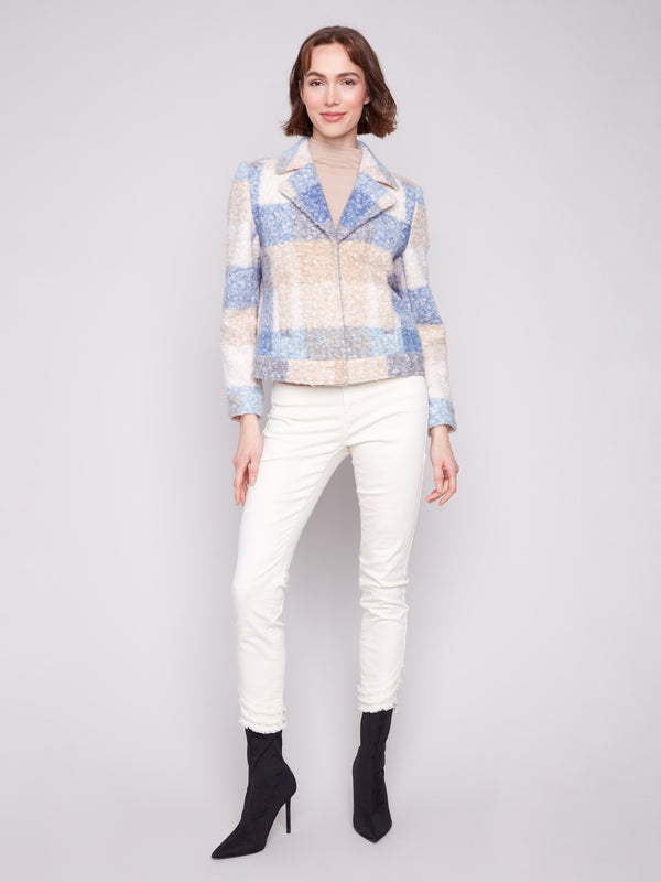 This short coat showcases elegant welt pockets, adding functionality to its fashionable design in blue and beige plaid by Charlie B.