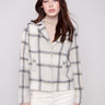 Beige plaid short coat with a tailored collar, hidden snap buttons, and welt pockets. Features long sleeves by Charlie B.