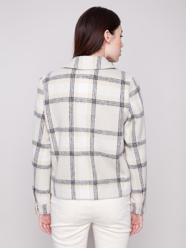 Classic beige plaid coat featuring snap button closure and elegant long sleeves. Tailored for style and comfort by Charlie B.
