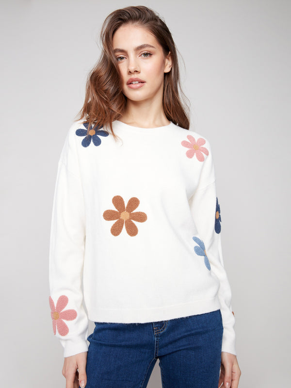 Ecru plush sweater with a cozy crew neckline adorned with colorful flower patterns by Charlie B.