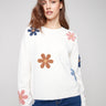 Ecru plush sweater with a cozy crew neckline adorned with colorful flower patterns by Charlie B.