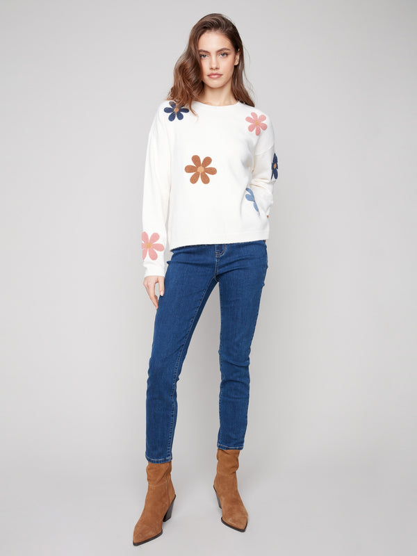Stylish drop shoulder design on this ecru plush sweater featuring vibrant floral details by Charlie B.