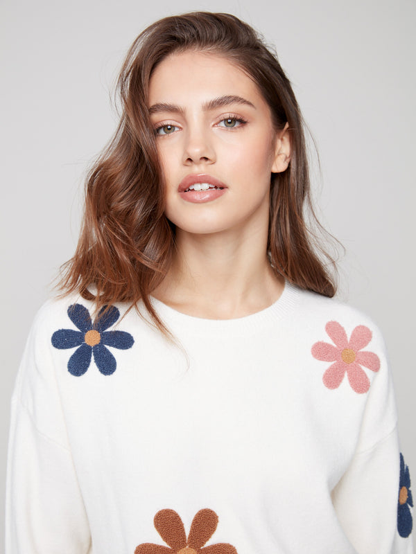 Soft plush fabric in ecru with eye-catching colorful boucle flower accents by Charlie B.