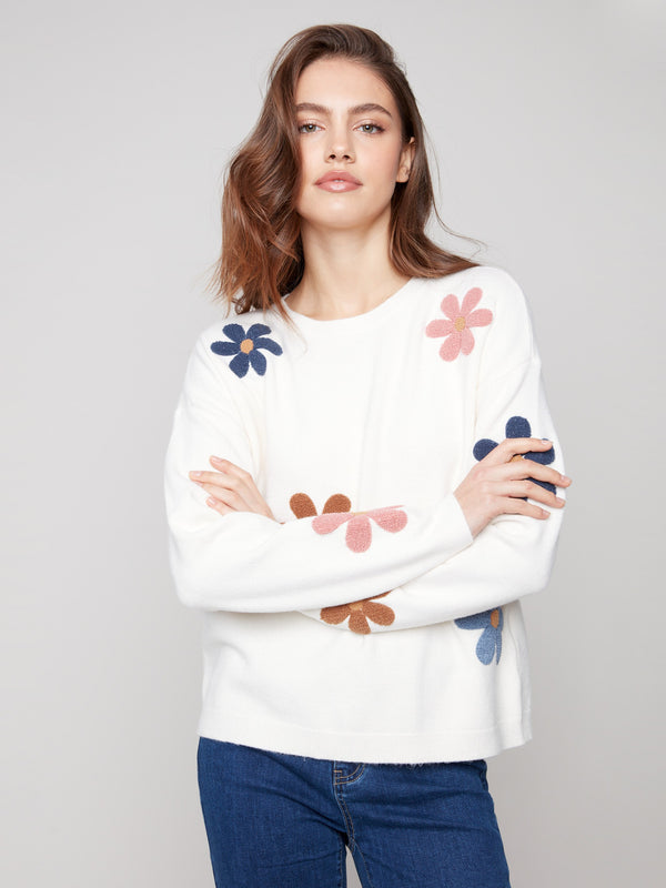 Long sleeves complement the playful flower motifs on this ecru plush sweater by Charlie B.