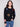 Black plush sweater with a crew neckline adorned with colorful boucle flower patches, creating a vibrant look by Charlie B.