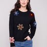 Black plush sweater with a crew neckline adorned with colorful boucle flower patches, creating a vibrant look by Charlie B.