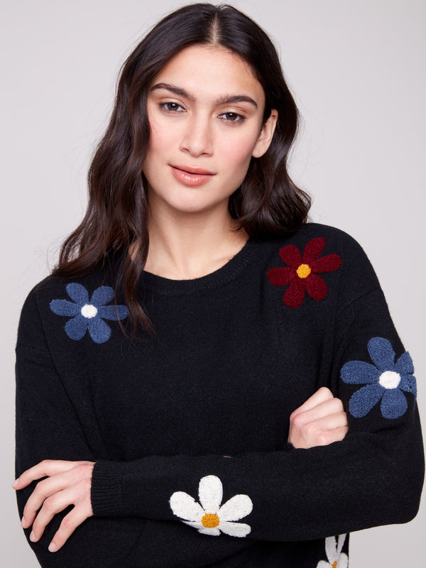 Sweater featuring plush fabric and colorful boucle flowers, offering both comfort and style by Charlie B.