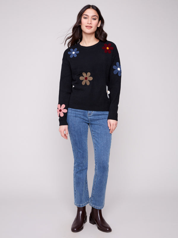 Stylish black sweater with drop shoulder design and vibrant flower patterns for a relaxed fit by Charlie B.