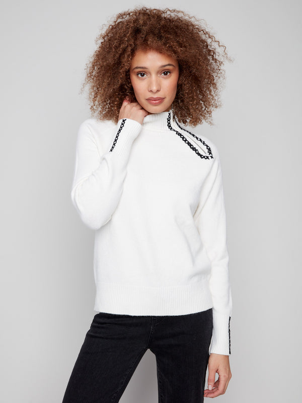 Ecru sweater showcasing intricate raglan sleeves and plush texture, perfect for a cozy look by Charlie B.