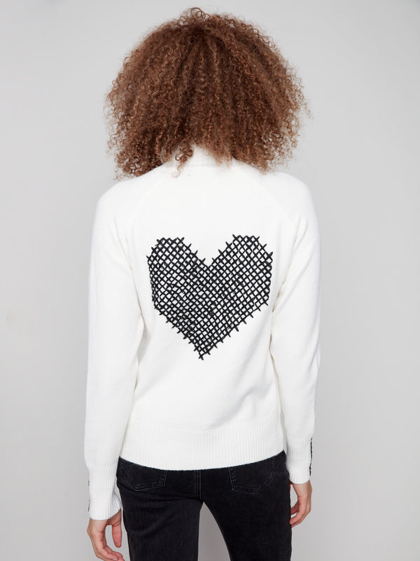 Sweater features elegant stitch details with a heart cross-stitch on the back, adding charm by Charlie B.