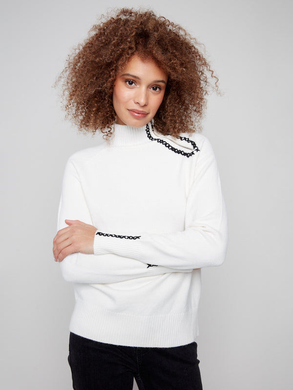 Plush ecru sweater highlighted by unique zipper detail and raglan sleeves for added style by Charlie B.