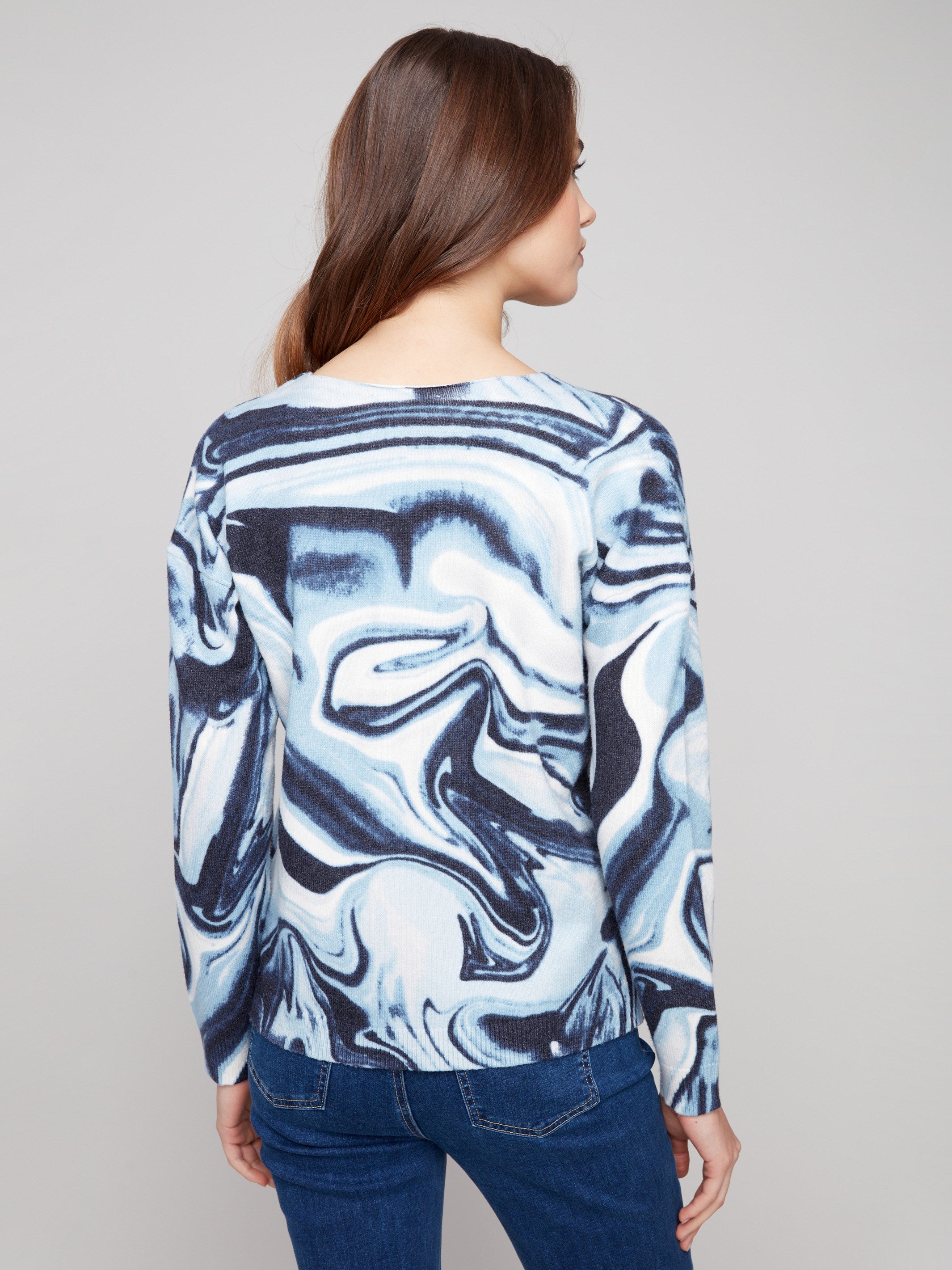 Stylish blue swirl sweater with side slits for added flair and movement by Charlie B.