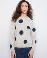 White sweater with navy polka dots, showcasing a speckled knit texture for added style by Charlie B.