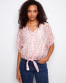 Polka dot blouse with a charming front tie knot, adding a playful touch to your outfit. Perfect for casual outings by Charlie B.
