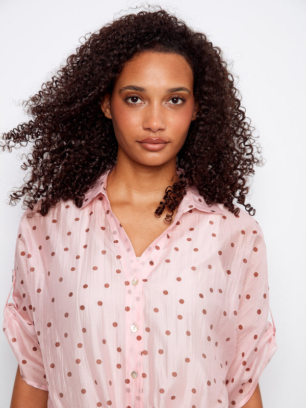 This semi-sheer polka dot blouse offers a stylish V-neckline, blending elegance with comfort effortlessly by Charlie B.