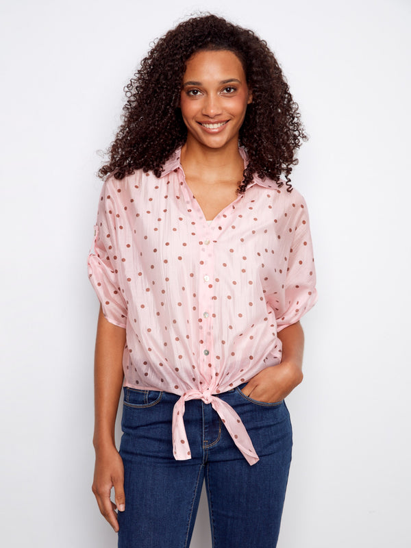 A chic polka dot pattern adorns this semi-sheer blouse, ideal for layering or standalone wear by Charlie B.