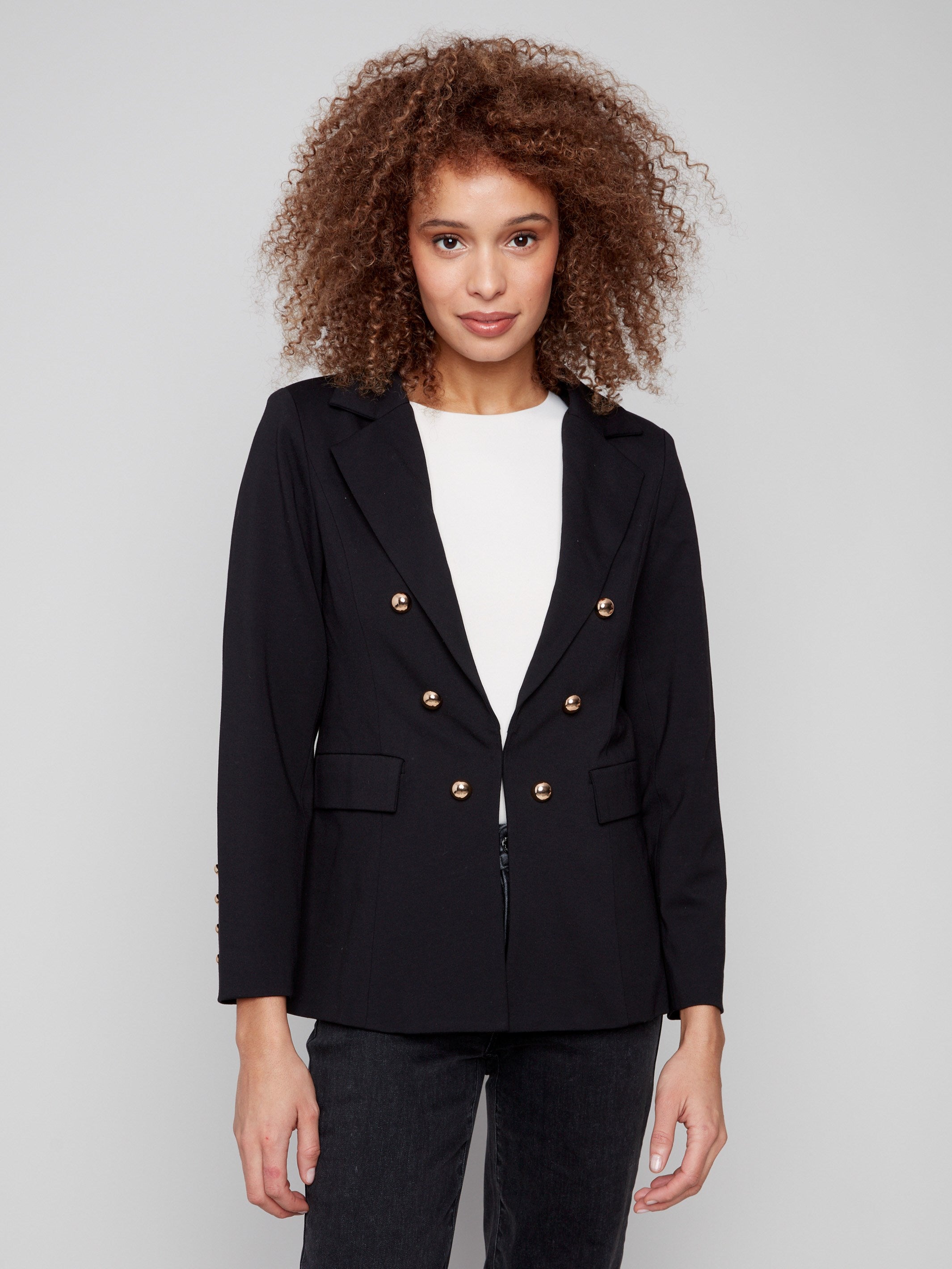 Chic black blazer featuring practical flap pockets, combining style and functionality effortlessly by Charlie B.