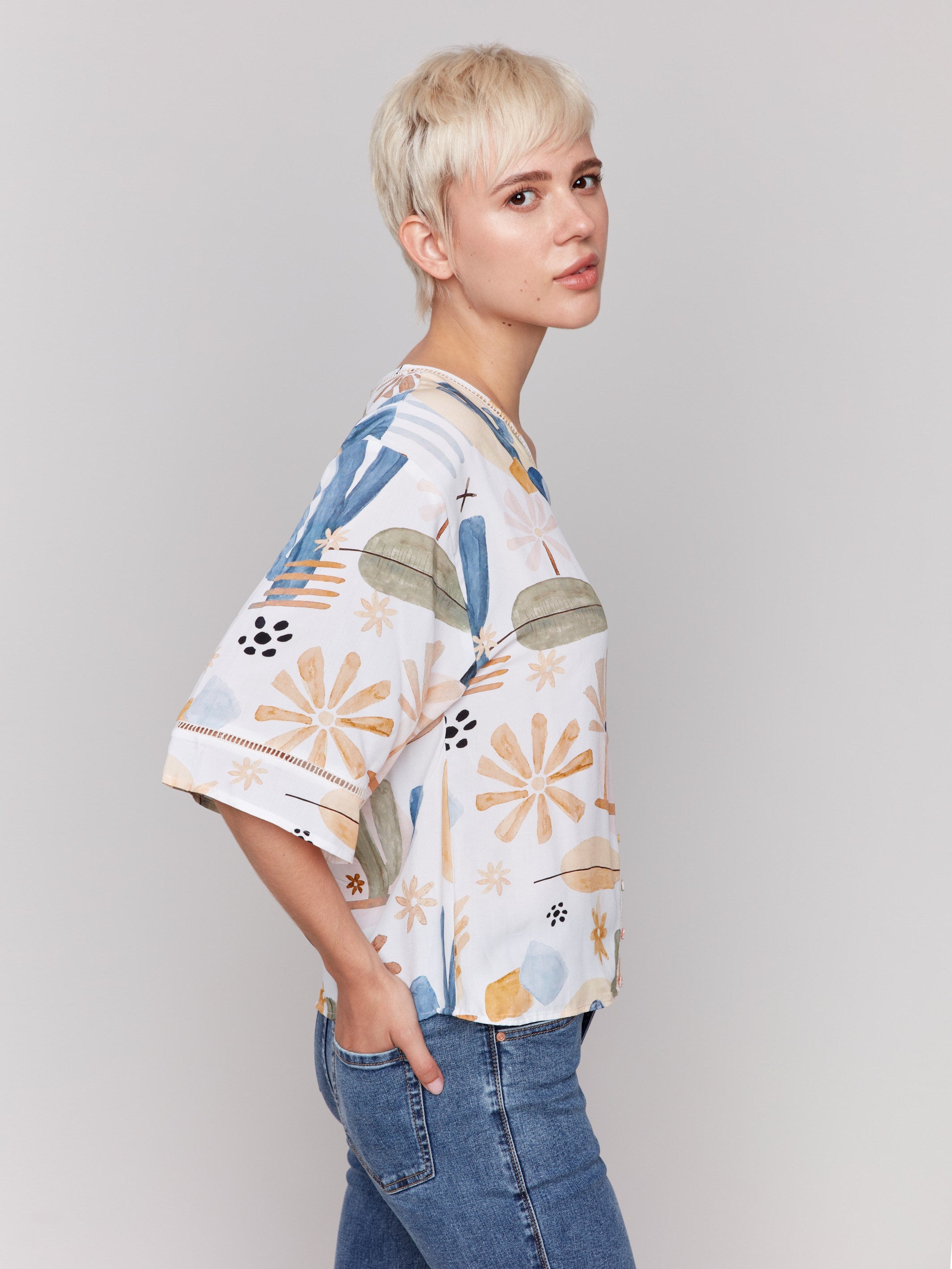 Decorative buttons accentuate this stylish blouse by Charlie B.