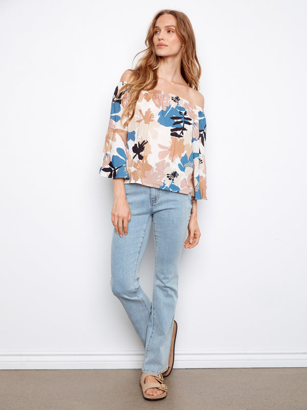 Lightweight fabric enhances the comfort of this floral-patterned, off-the-shoulder top by Charlie B.