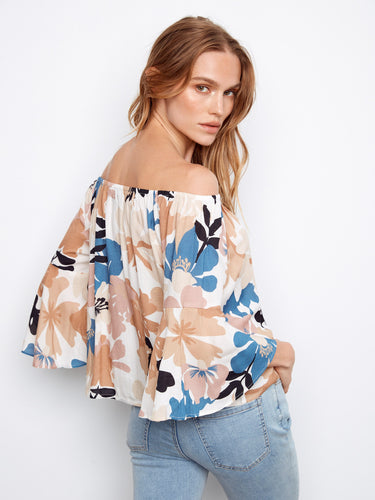 This fashionable top features an off-the-shoulder design and vibrant floral pattern for a fresh style by Charlie B.