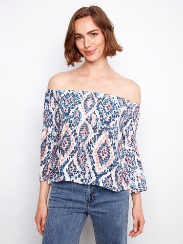 Elegant off-the-shoulder blouse with eye-catching abstract designs in soft, airy fabric by Charlie B.