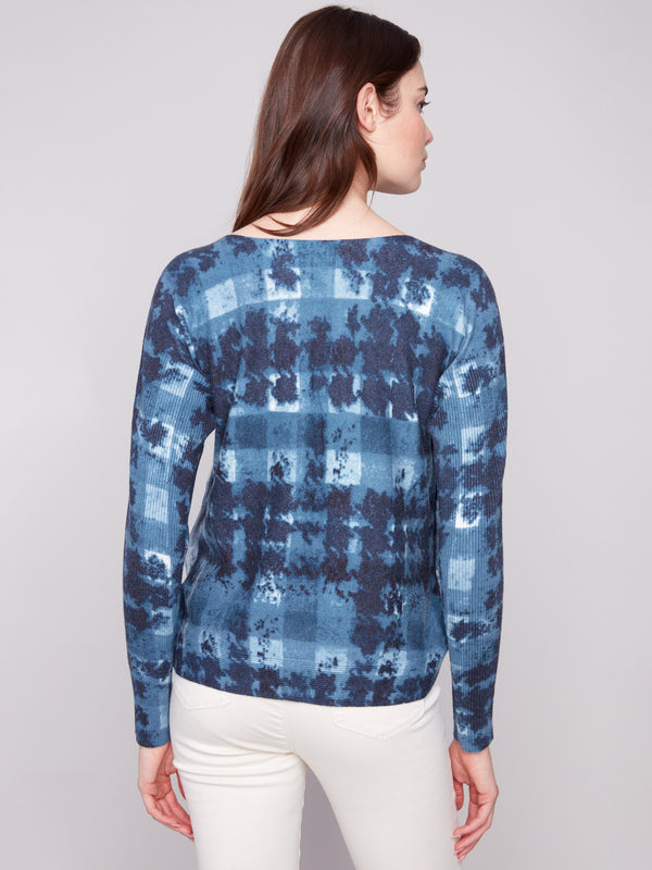 Fashionable sweater with ribbed sleeves and intricate shadow printing, offering comfort and style by Charlie B.