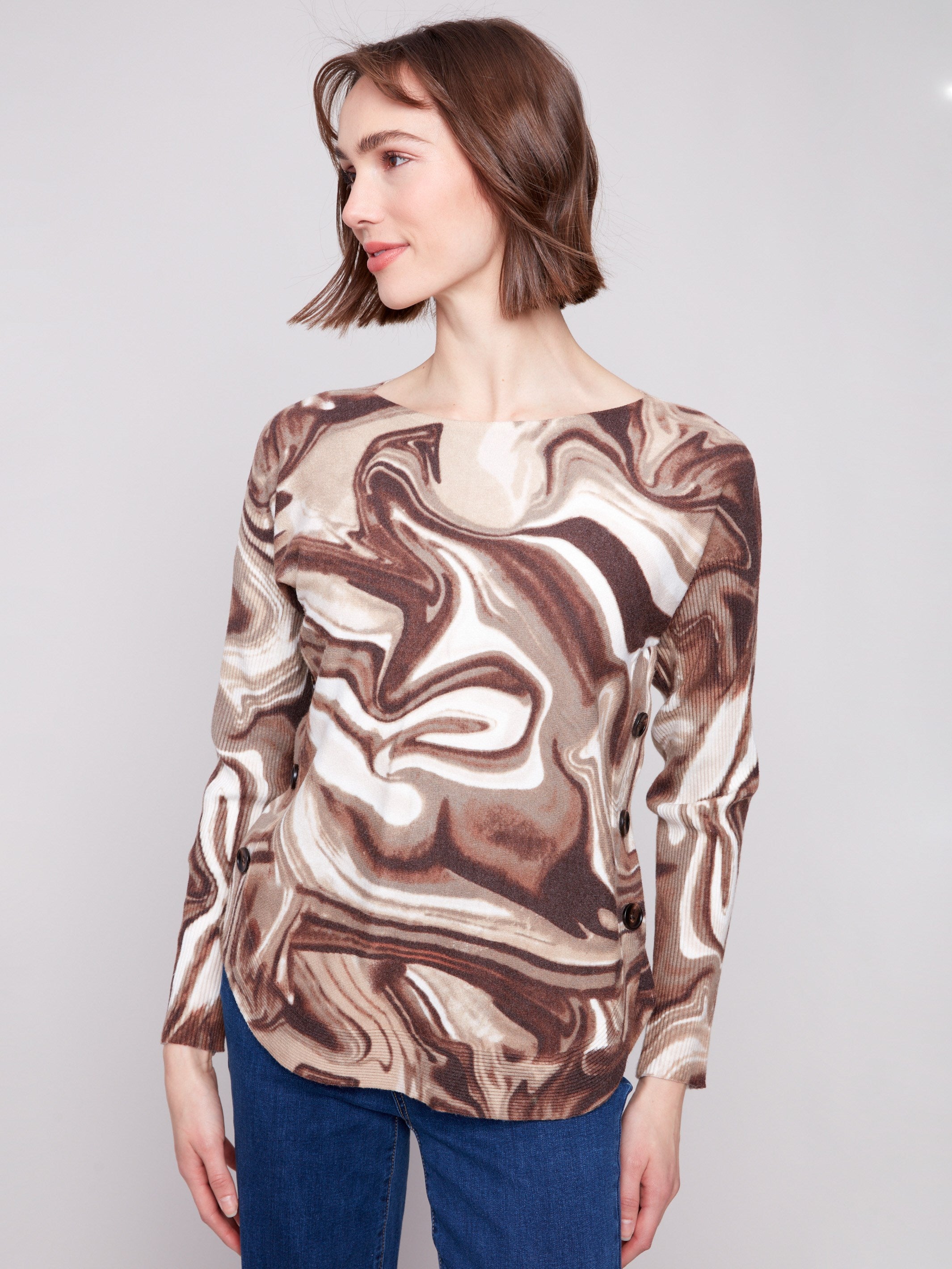 Elegant sweater with rounded hem and artistic swirl design, perfect for casual outings by Charlie B.