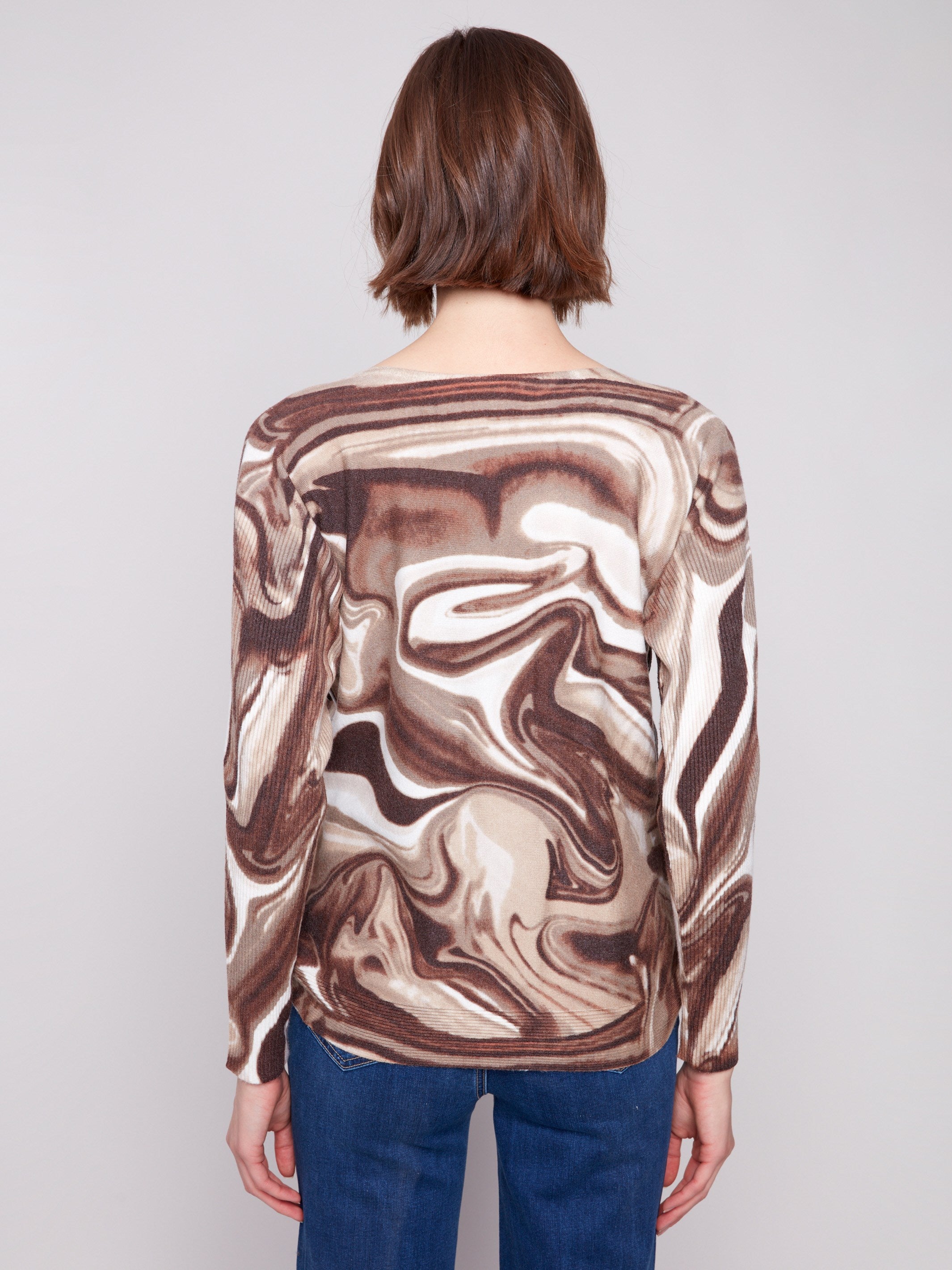 Chic long-sleeve sweater showcasing ribbed sleeves and a unique swirl pattern by Charlie B.