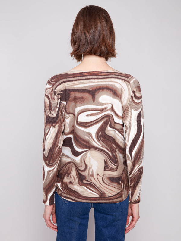 Chic long-sleeve sweater showcasing ribbed sleeves and a unique swirl pattern by Charlie B.