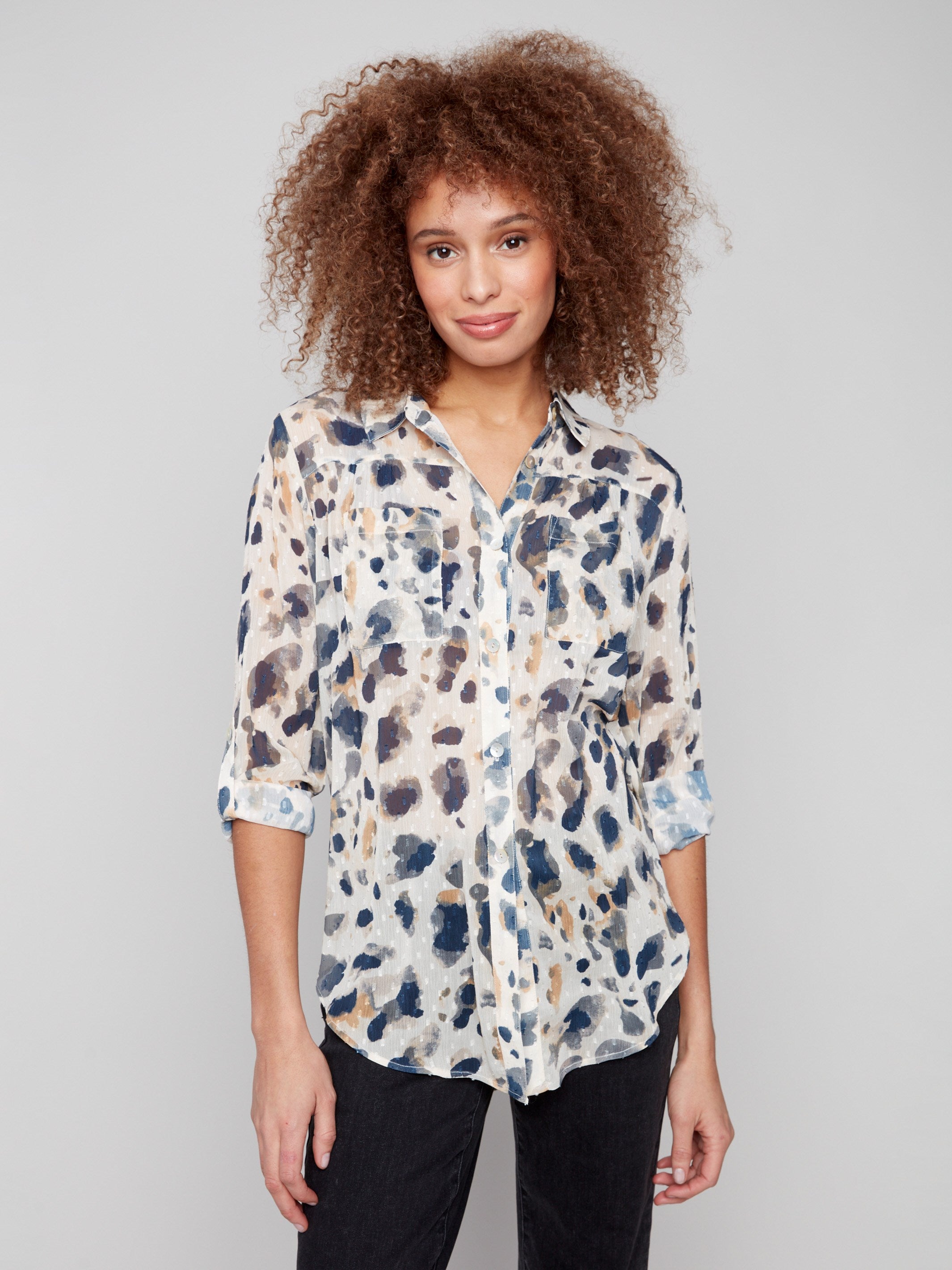 Semi-sheer animal print blouse with chest pockets and adjustable roll-up sleeves for versatile styling by Charlie B.