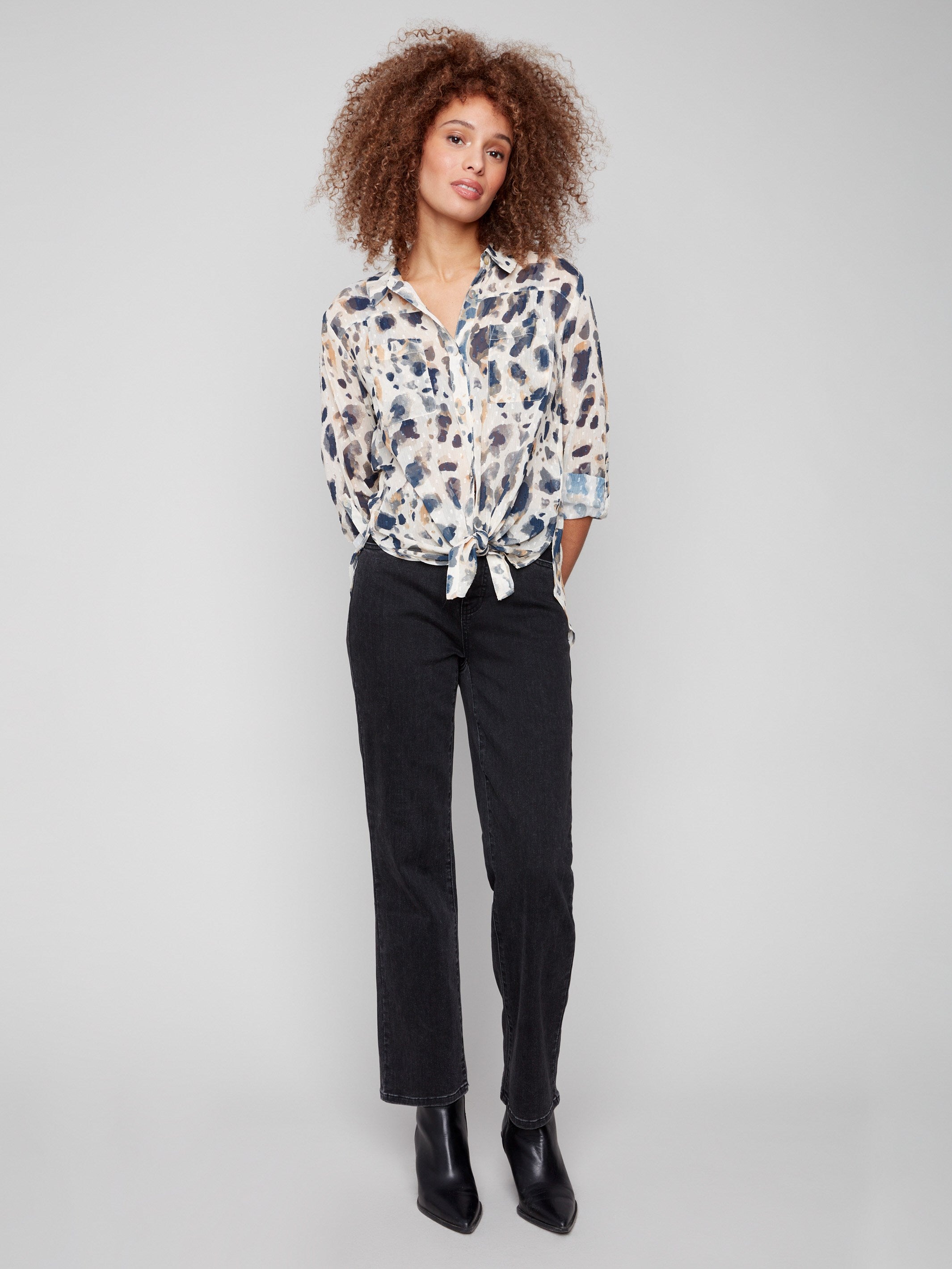 Stylish shirt collar blouse with side slits and semi-sheer fabric, offering a modern twist on classic design by Charlie B.