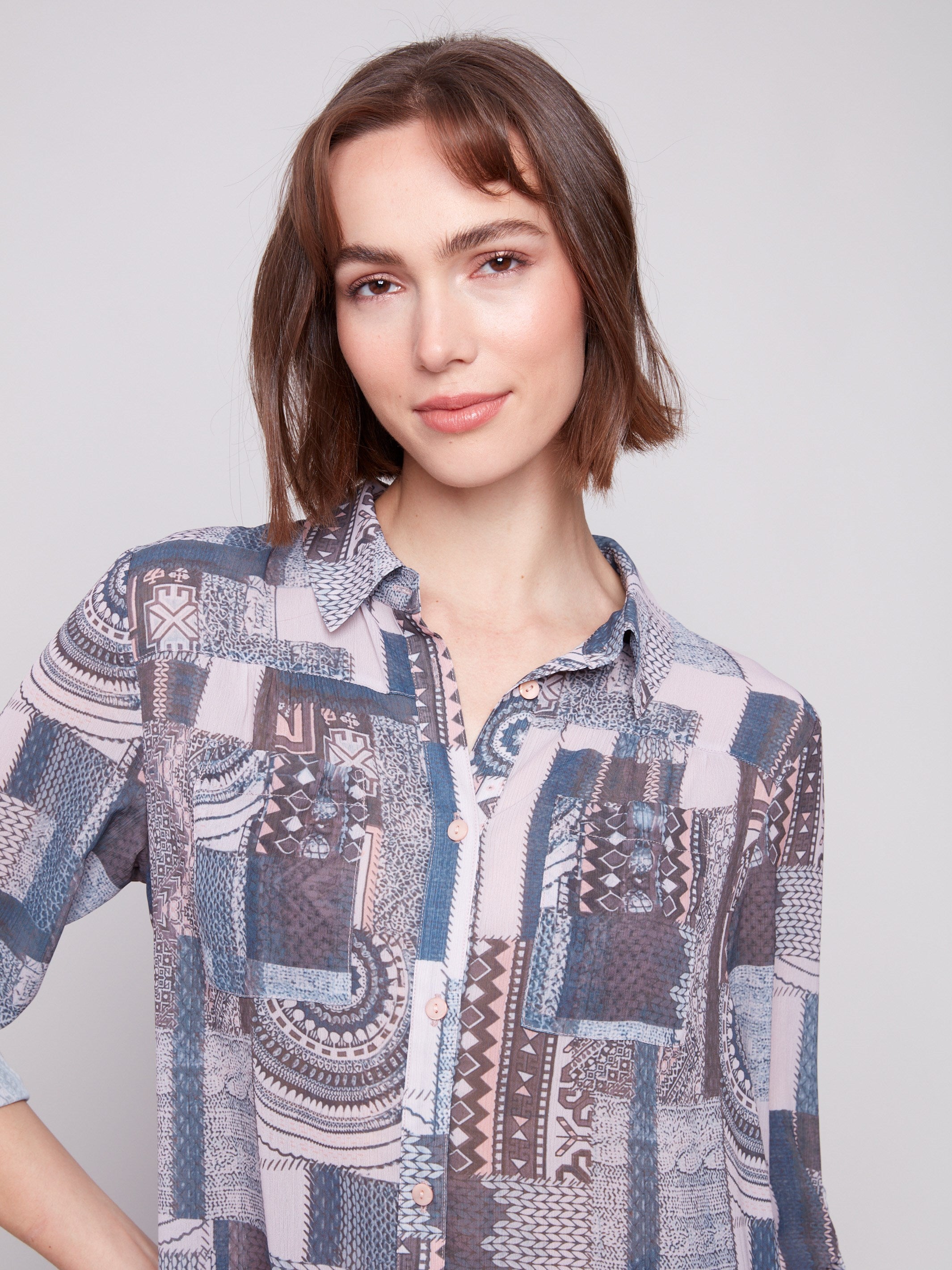 Stylish patchwork blouse highlighting chest pockets and intricate patterns for added flair by Charlie B.